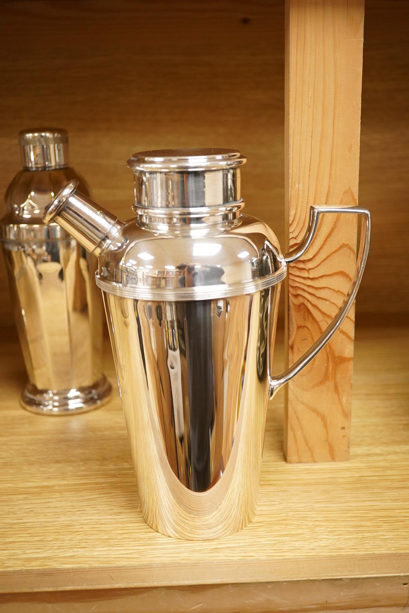 A mid 20th century silver plated patent cocktail shaker with recipes, two other cocktail shakers and an ice bucket, largest 28cm high